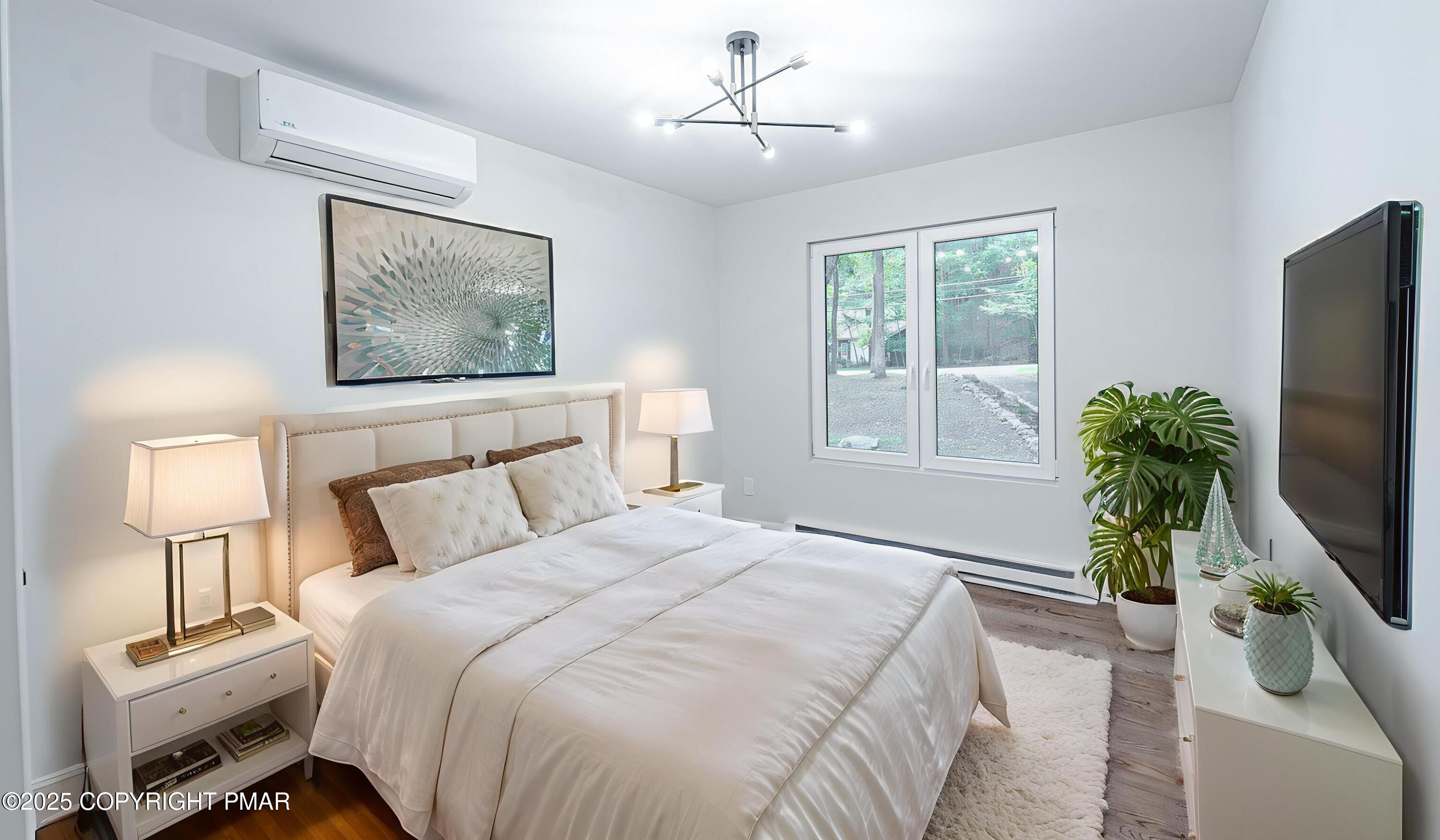 5806 Decker Road Bushkill, PA 18324 - Photo 51 of 76 a bedroom with a bed and a flat screen tv