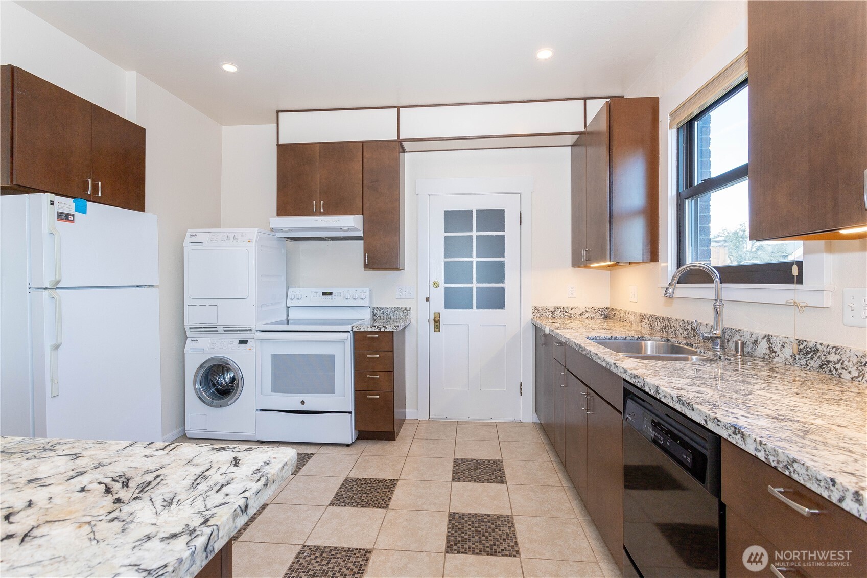 3010 East Spruce Street Seattle, WA 98122 - Photo 11 of 20 a kitchen with a stove a sink and a refrigerator