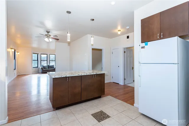 a view of kitchen with refrigerator and cabinets