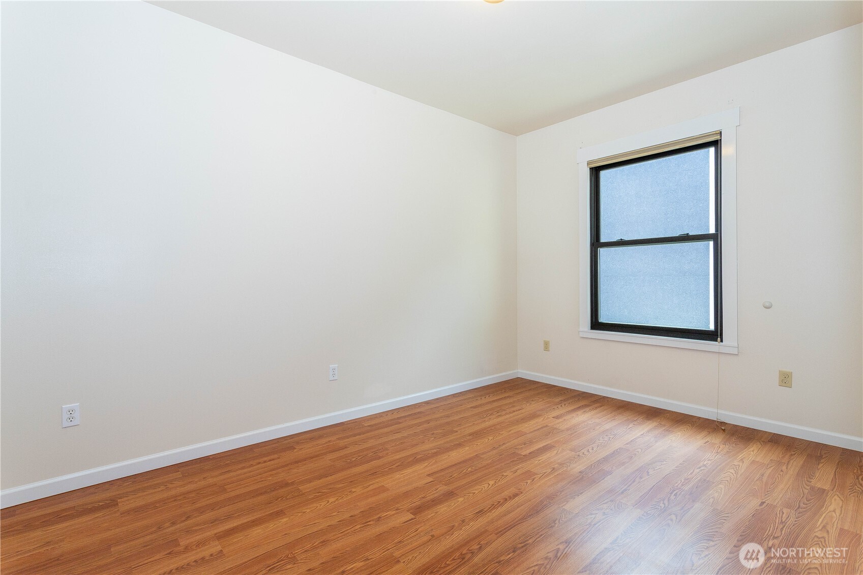 3010 East Spruce Street Seattle, WA 98122 - Photo 18 of 20 an empty room with wooden floor and windows
