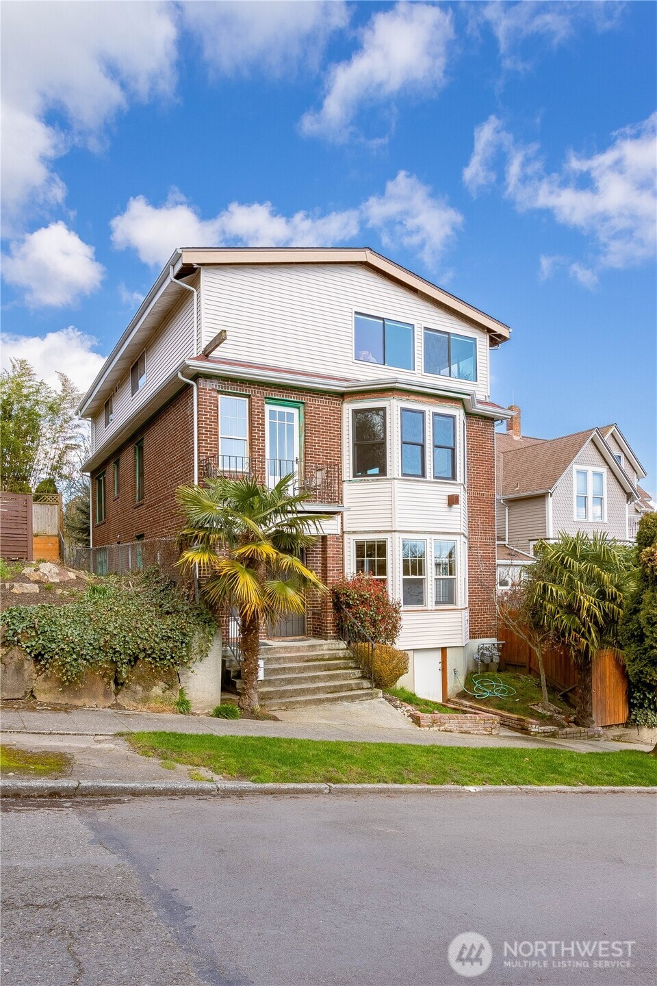 3010 East Spruce Street Seattle, WA 98122 - Photo 2 of 20 a front view of a house with a yard