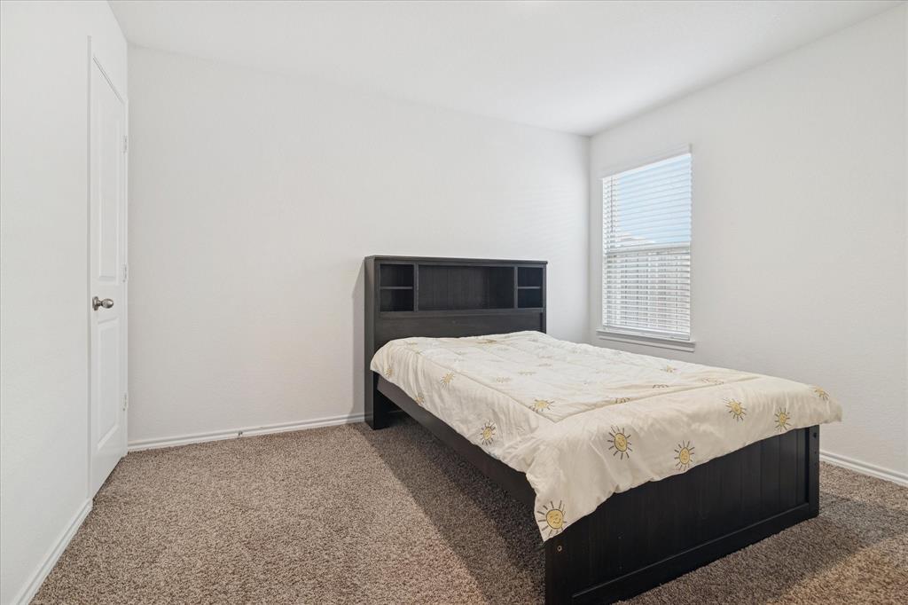 1132 Rountree Court Celina, TX 75009 - Photo 17 of 27 Another spacious secondary bedroom split from the primary.
