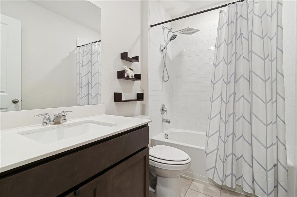 1132 Rountree Court Celina, TX 75009 - Photo 18 of 27 The 3rd full bath situated in between 2 of the secondary bedrooms.