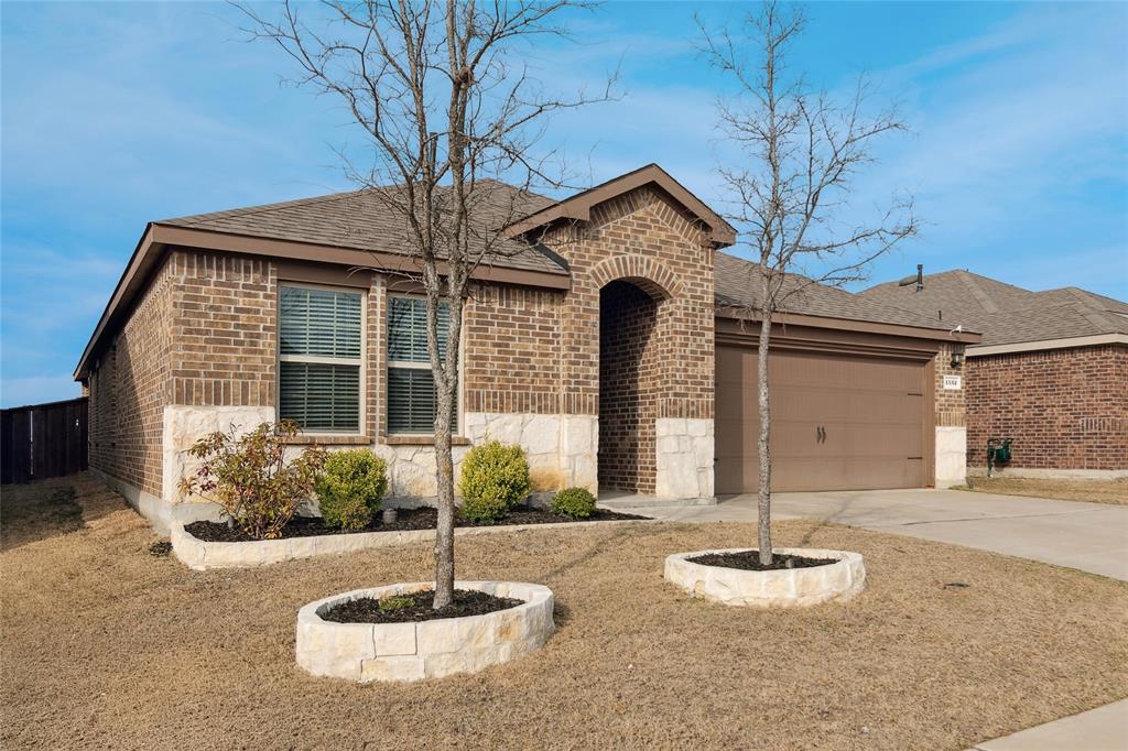 1132 Rountree Court Celina, TX 75009 - Photo 2 of 27 Beautiful stone faced accents with stone edged flower beds adding to its curb appeal!
