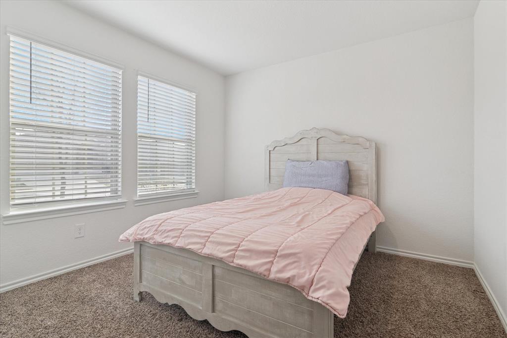 1132 Rountree Court Celina, TX 75009 - Photo 4 of 27 Spacious front bedroom with amazing natural light.