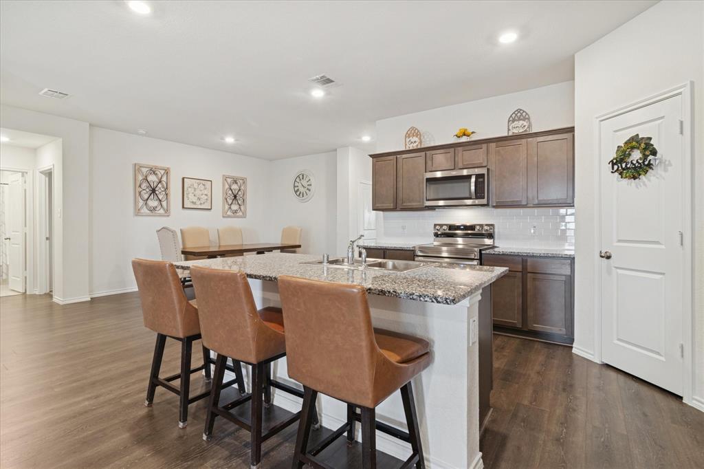 1132 Rountree Court Celina, TX 75009 - Photo 8 of 27 Open Kitchen with large island and room for bench stools.