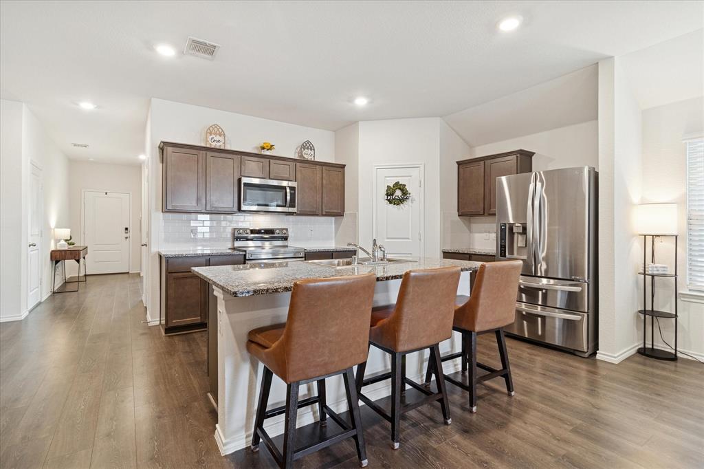 1132 Rountree Court Celina, TX 75009 - Photo 9 of 27 Kitchen offers granite tops, and stainless steel appliances. Refrigerator included! (Thanks Sellers)