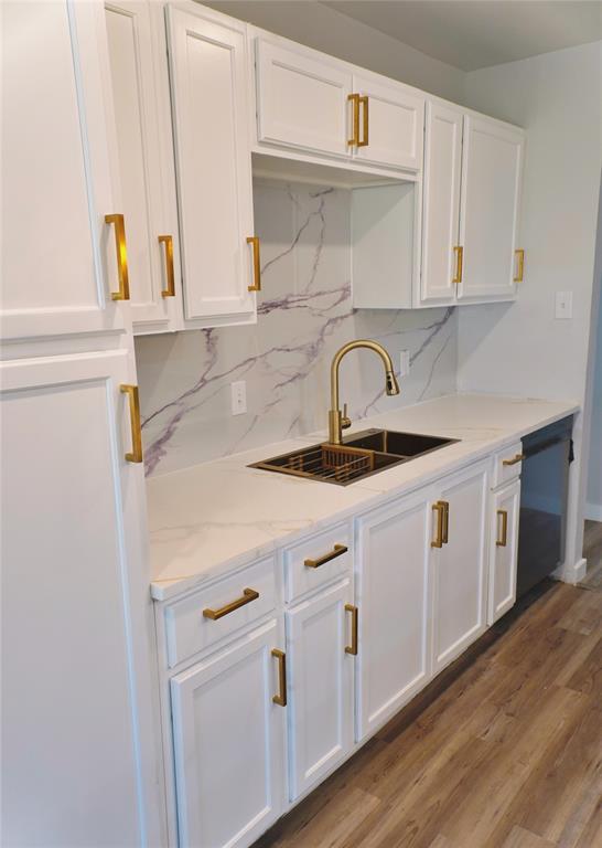 6357 Cascade Circle Watauga, TX 76148 - Photo 3 of 22 a kitchen with a sink cabinets and wooden floor