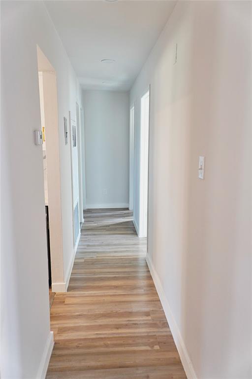6357 Cascade Circle Watauga, TX 76148 - Photo 4 of 22 a view of a hallway with wooden floor and staircase