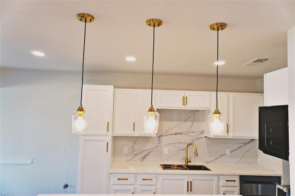 6357 Cascade Circle Watauga, TX 76148 - Photo 7 of 22 a kitchen with kitchen island a counter top space appliances and a cabinets