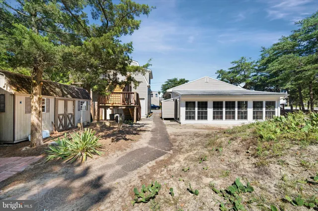 a view of a house with a tree in front of it