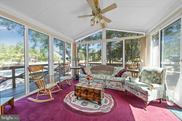 a living room with furniture and a floor to ceiling window