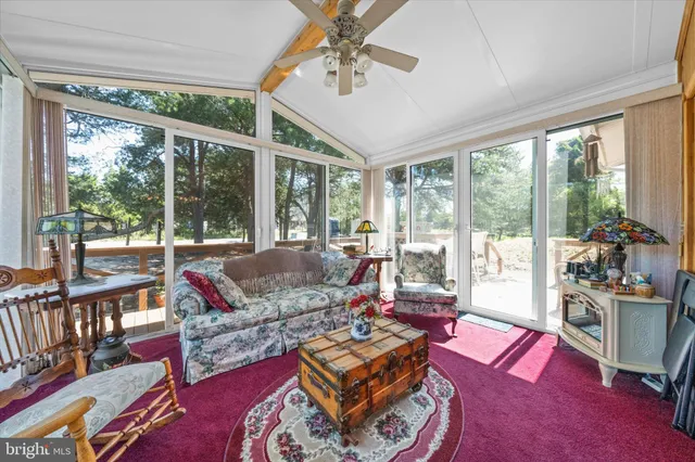 a living room with furniture fireplace and a large window
