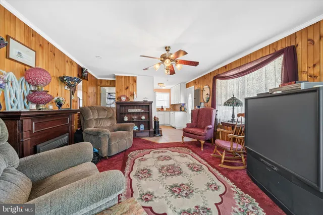 a living room with furniture a rug and a window
