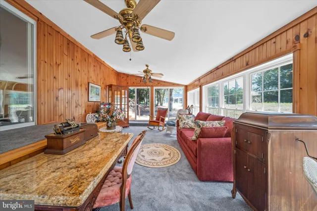 a living room with furniture a rug and a large window