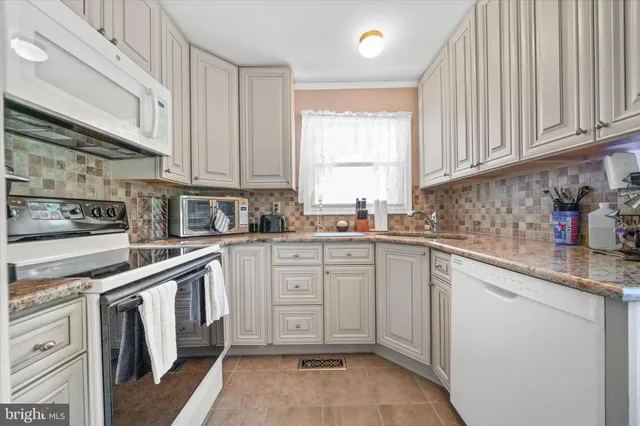 a spacious bedroom with a bed and wooden floor