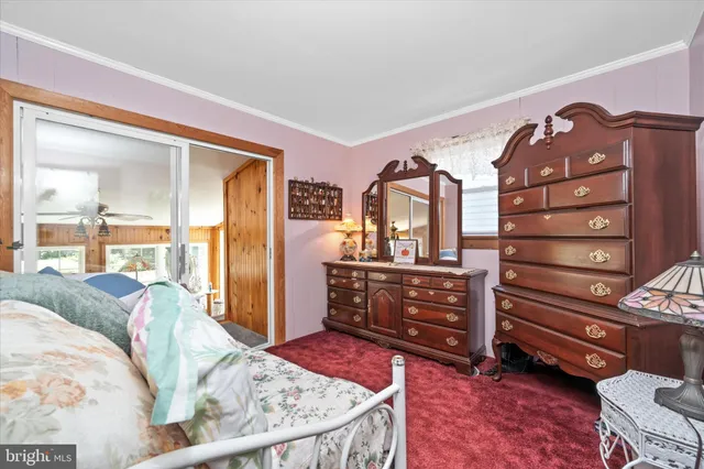 a bedroom with a bed dresser and a window