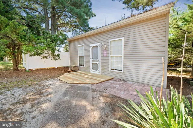 a living room with stainless steel appliances kitchen island granite countertop furniture a rug and a window