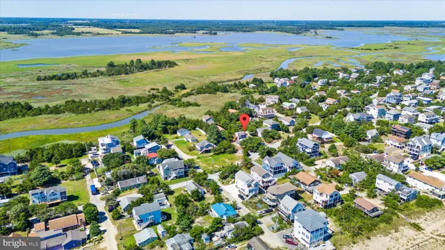 an aerial view of residential house with outdoor space and trees all around