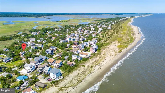 an aerial view of a house with a yard and garden