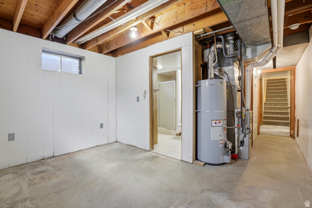 2348 North 770 West Clinton, UT 84015 - Photo 16 of 25 Basement space featuring concrete flooring, white paneled walls, and exposed ceiling joists