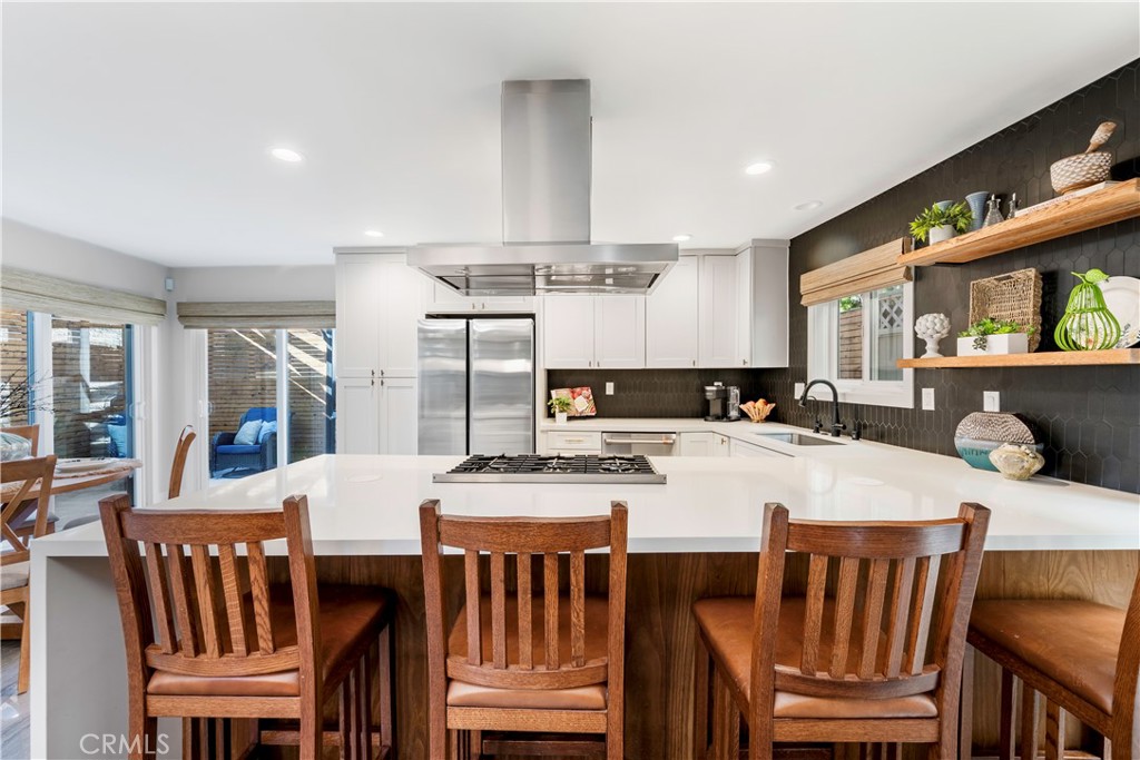 35 Geneva Walk Long Beach, CA 90803 - Photo 13 of 36 a kitchen with a dining table chairs and refrigerator