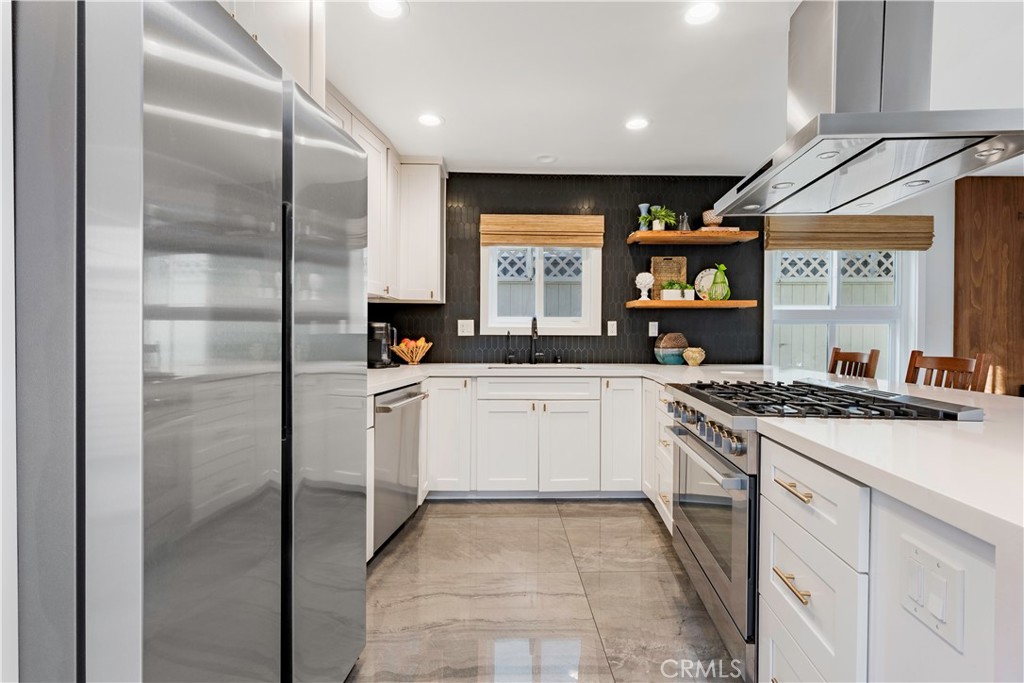 35 Geneva Walk Long Beach, CA 90803 - Photo 15 of 36 a kitchen with stainless steel appliances granite countertop a stove a sink and a refrigerator