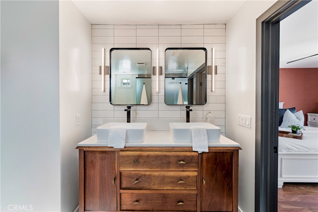 35 Geneva Walk Long Beach, CA 90803 - Photo 34 of 36 a bathroom with mirror two sinks and a wooden floor