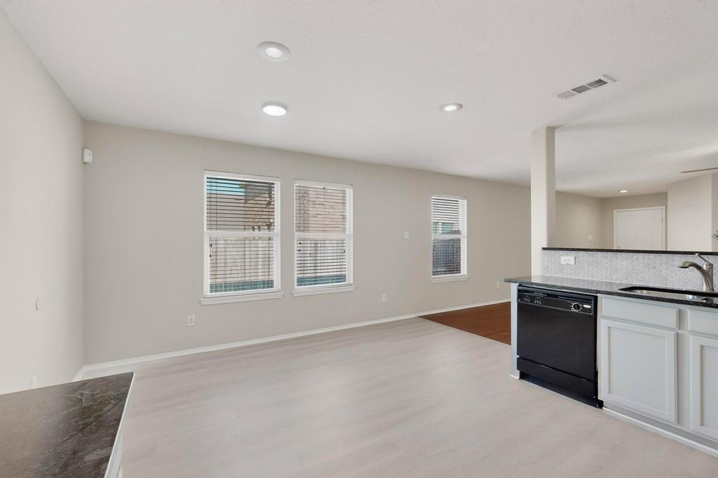 303 Laurel Lane Fate, TX 75087 - Photo 16 of 33 a view of a kitchen with stainless steel appliances granite countertop a stove and a sink