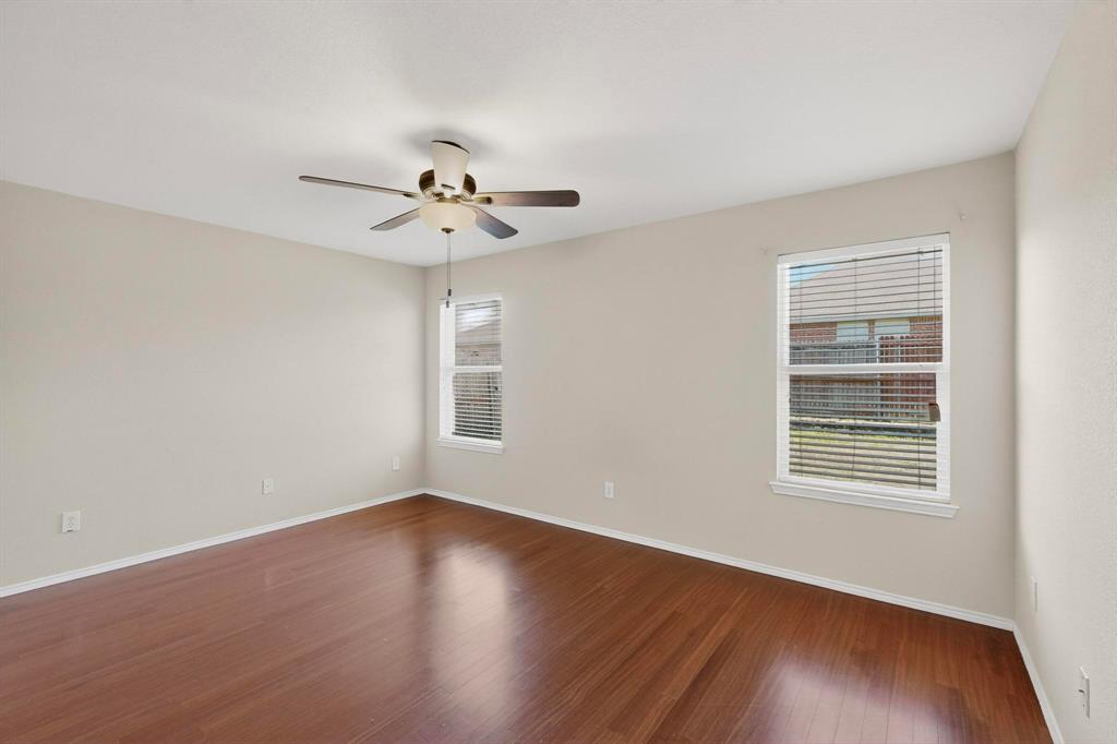 303 Laurel Lane Fate, TX 75087 - Photo 17 of 33 a view of an empty room with wooden floor and a window