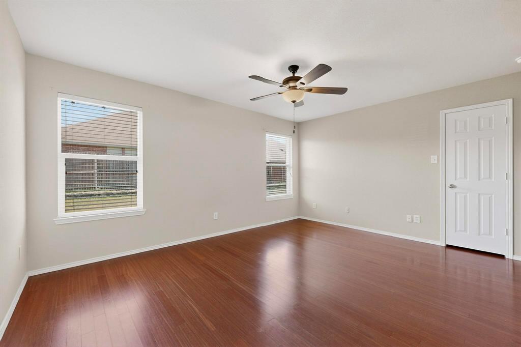303 Laurel Lane Fate, TX 75087 - Photo 18 of 33 a view of an empty room with wooden floor and a window