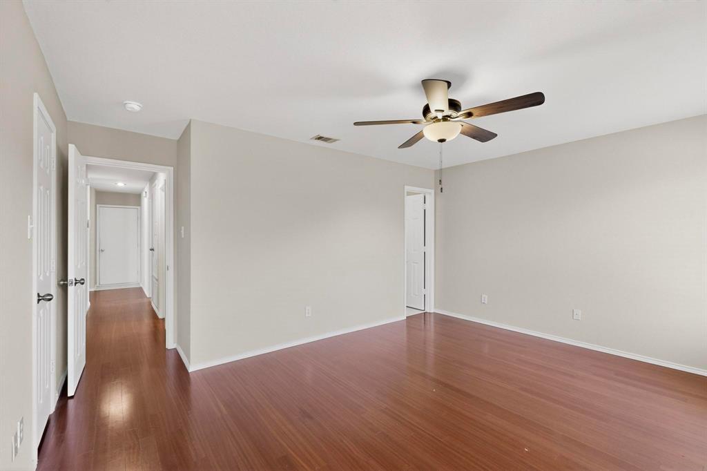 303 Laurel Lane Fate, TX 75087 - Photo 20 of 33 a view of a room with wooden floor and a ceiling fan
