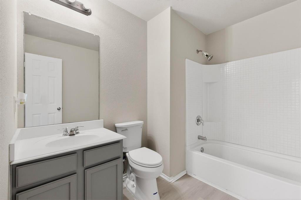 303 Laurel Lane Fate, TX 75087 - Photo 22 of 33 a bathroom with a sink a toilet and a bathtub