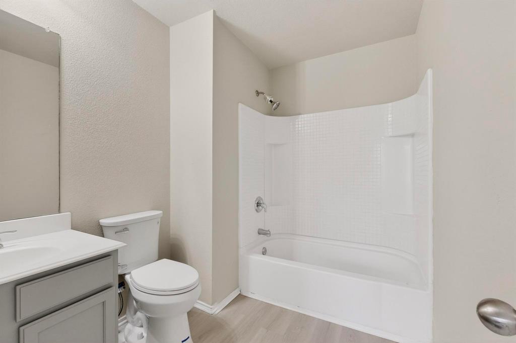 303 Laurel Lane Fate, TX 75087 - Photo 23 of 33 a white toilet sitting next to a bath tub