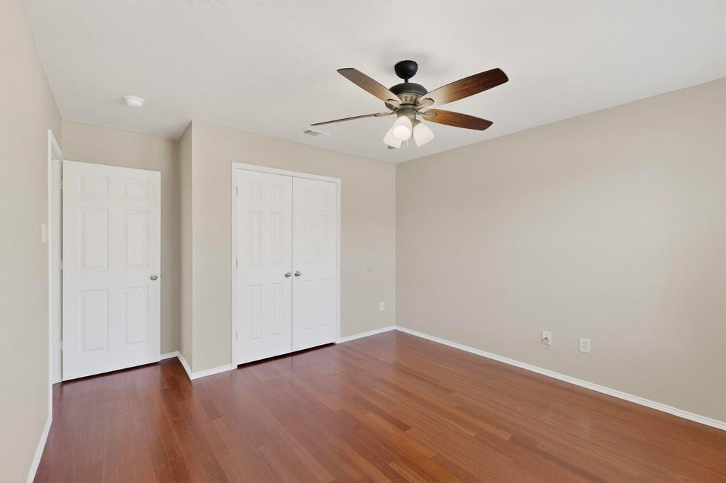 303 Laurel Lane Fate, TX 75087 - Photo 26 of 33 a view of a big room with wooden floor closet ceiling fan and wooden floor