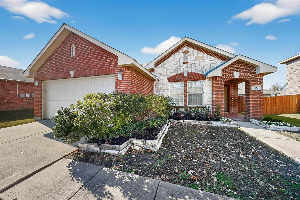 303 Laurel Lane Fate, TX 75087 - Photo 3 of 33 a front view of a house with a yard