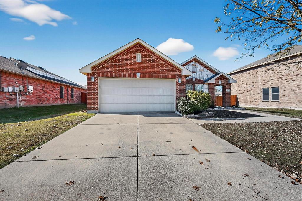 303 Laurel Lane Fate, TX 75087 - Photo 6 of 33 a front view of a house with a yard and garage