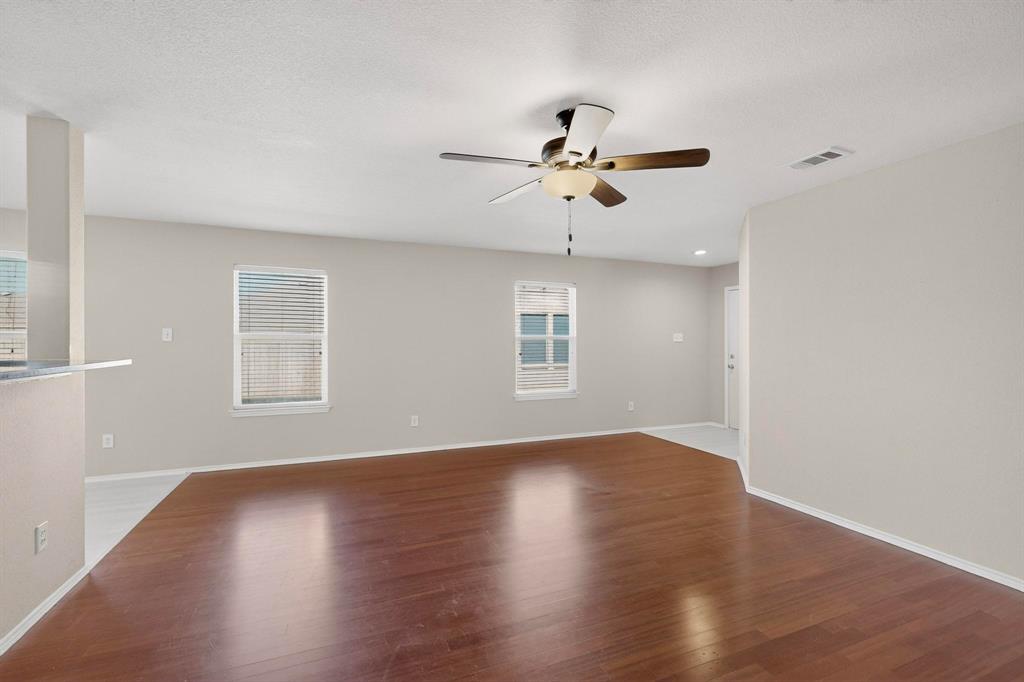 303 Laurel Lane Fate, TX 75087 - Photo 10 of 33 a view of a big room with wooden floor and a chandelier fan