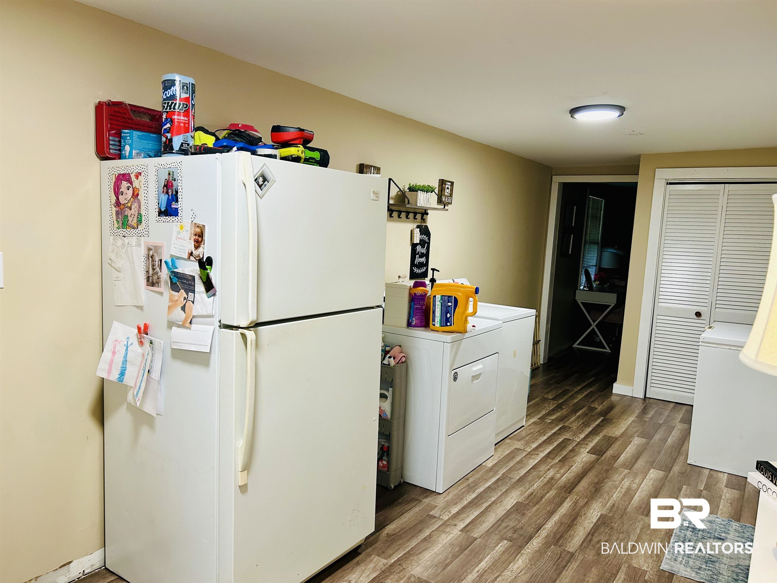 3850 Newman Road Mobile, AL 36695 - Photo 27 of 27 Kitchen featuring white cabinets, white fridge, washer / dryer, and light wood-type flooring
