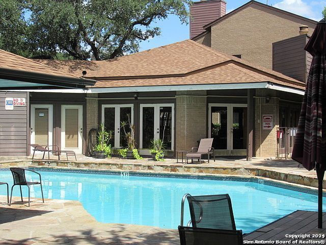 a view of outdoor space with swimming pool and porch