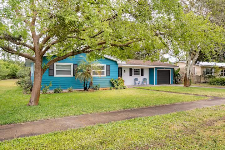 238 Lily Road St. Augustine Shores, FL 32086 - Photo 1 of 22 a front view of a house with a garden and trees