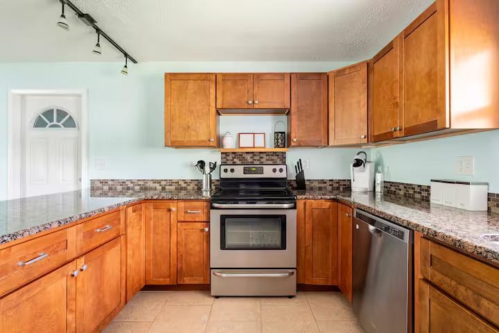 238 Lily Road St. Augustine Shores, FL 32086 - Photo 13 of 22 a kitchen with granite countertop a sink stove and cabinets