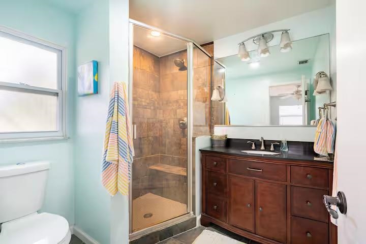 238 Lily Road St. Augustine Shores, FL 32086 - Photo 17 of 22 a bathroom with a granite countertop sink toilet and shower