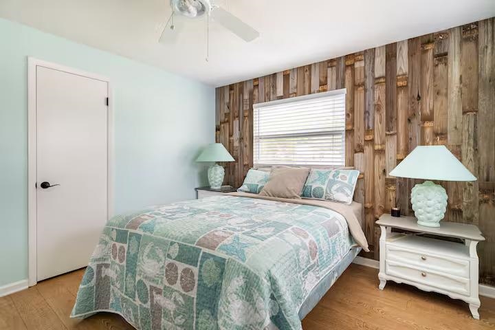 238 Lily Road St. Augustine Shores, FL 32086 - Photo 19 of 22 a bedroom with a bed a lamp and a window