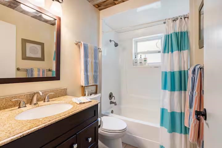 238 Lily Road St. Augustine Shores, FL 32086 - Photo 20 of 22 a bathroom with a granite countertop sink toilet and shower
