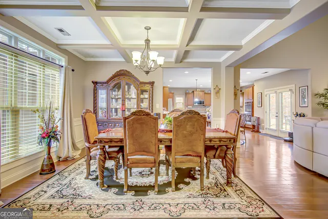 a kitchen with a table chairs stove and wooden floor