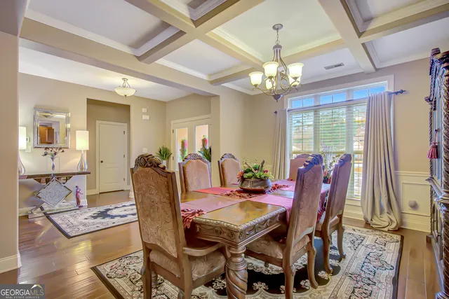 a living room with furniture a wooden floor and a chandelier