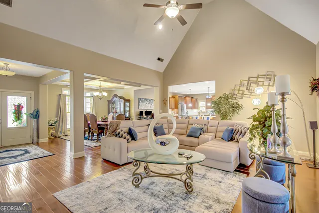 a large kitchen with kitchen island granite countertop lots of white cabinets appliances and furniture