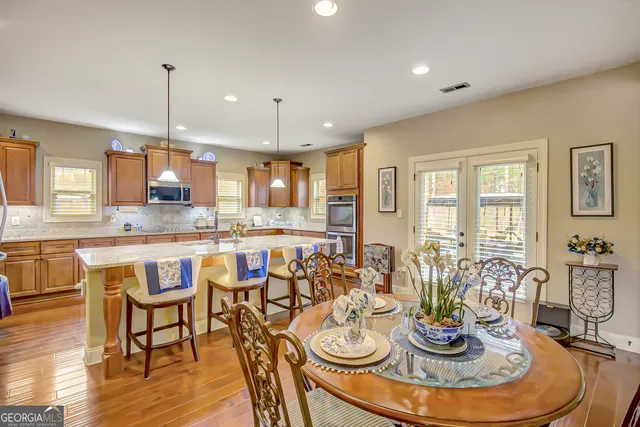 a kitchen with stainless steel appliances granite countertop a stove sink and cabinets