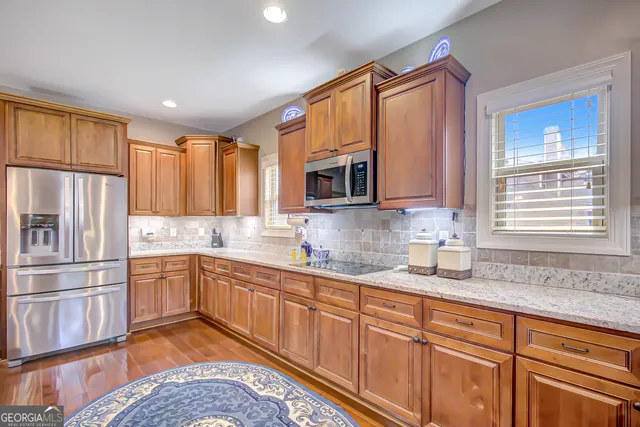 a view of a hallway with wooden floor and closet